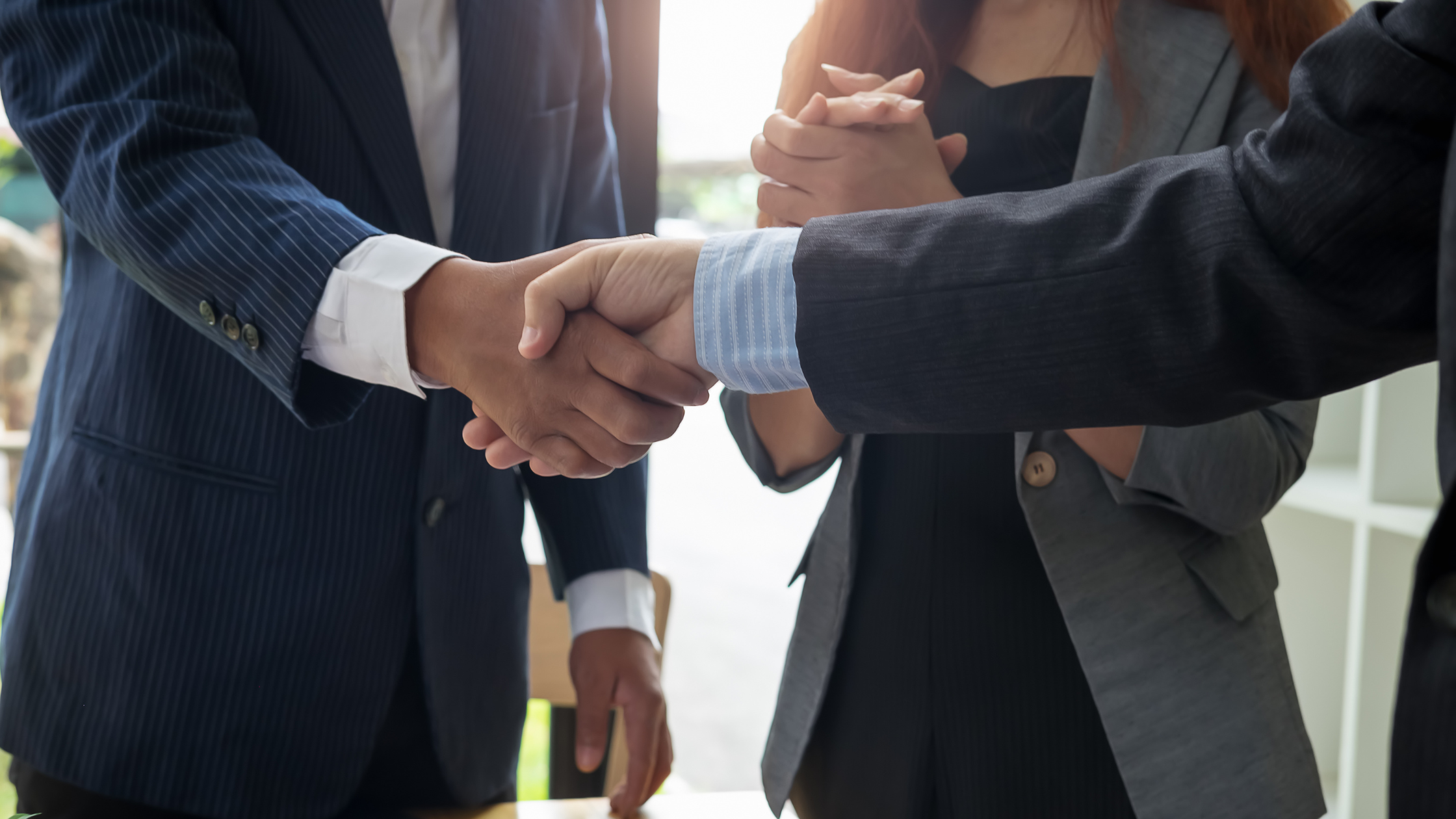 Shaking hands after a business deal- How Long Does It Take to Sell a Business? - The Tampa Business Broker
