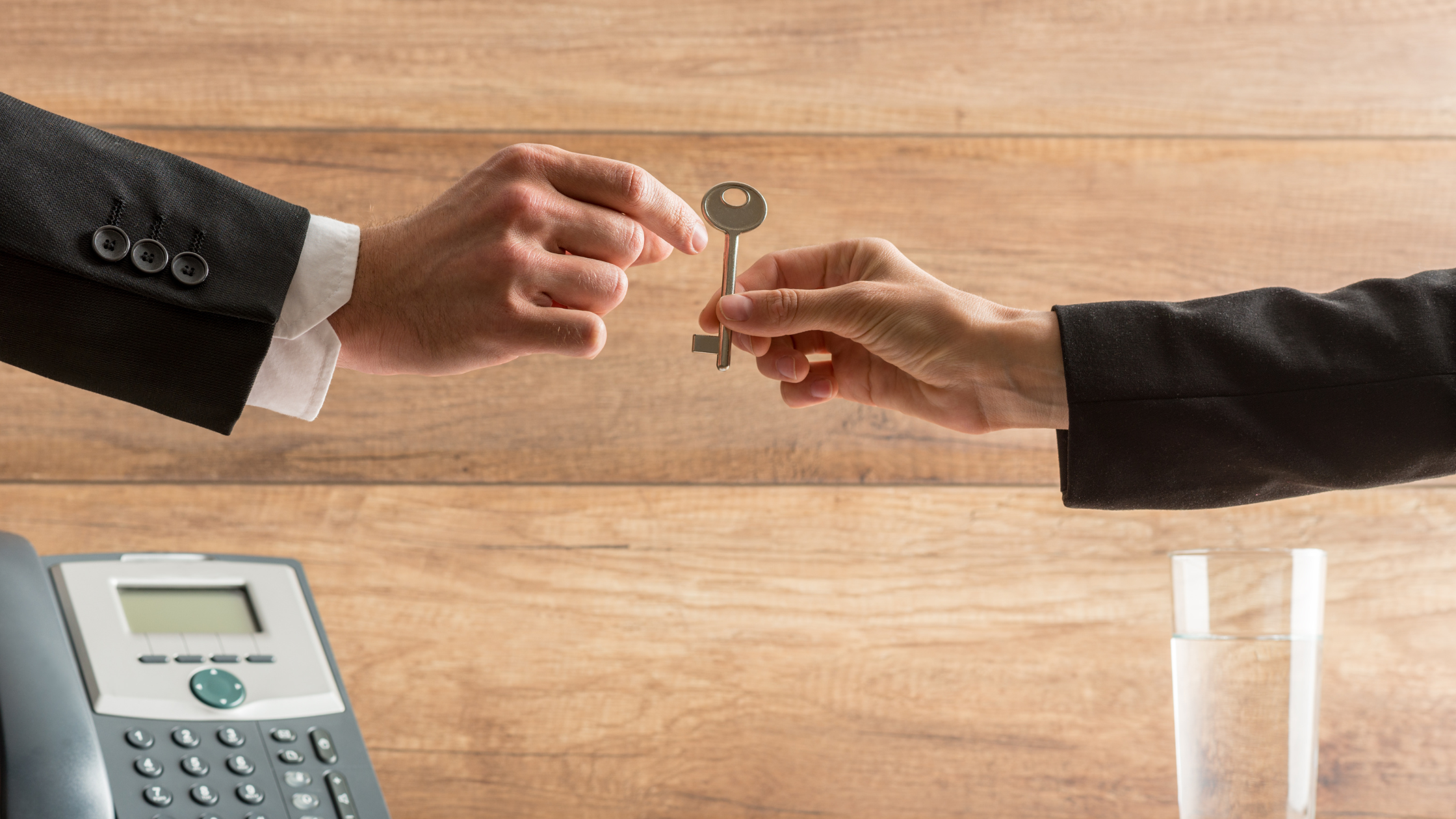 business seller handing keys to buyer-Tips for Reducing Owner Dependence When Selling Your Business: The Tampa Business Broker